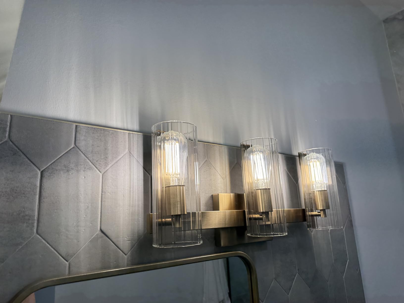 Kichler Jemsa 3-Light Bathroom Vanity Light Fixture with Clear Fluted Glass in Champagne Bronze for Modern Bathroom or Powder Room Wall Lighting (9.75 x 22.75 in), 55168CPZ customer photo 2