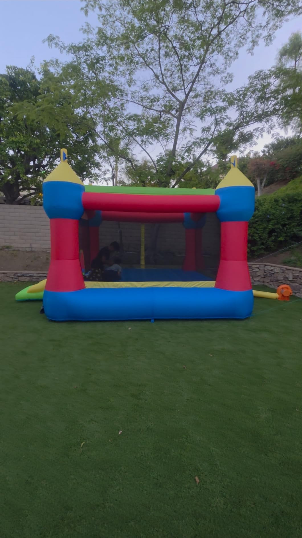 Bounceland Inflatable Party Castle Bounce House Bouncer, 16 ft L x 13 ft W x 10.3 ft H, Basketball Hoop, Removable Sun Roof, UL Strong Blower included, Fun Slide and Bounce Area, Castle Theme for Kids customer photo 2